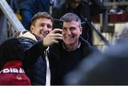 20 October 2023; Republic of Ireland MNT manager Stephen Kenny takes a selfie with a supporter at the SSE Airtricity Men's First Division match between Galway United and Wexford at Eamonn Deacy Park in Galway. Photo by Stephen McCarthy/Sportsfile