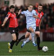 20 October 2023; Harry Wood of Shelbourne in action against Will Patching, left, and Shane McEleney of Derry City during the SSE Airtricity Men's Premier Division match between Derry City and Shelbourne at The Ryan McBride Brandywell Stadium in Derry. Photo by Ramsey Cardy/Sportsfile