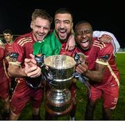 20 October 2023; Galway United players, from left, Rob Slevin, Wassim Aouachria and Francely Lomboto celebrate with the trophy after the during the SSE Airtricity Men's First Division match between Galway United and Wexford at Eamonn Deacy Park in Galway. Photo by Stephen McCarthy/Sportsfile