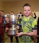 20 October 2023; Galway United goalkeeper Brendan Clarke celebrates with the trophy in the dressing room after the SSE Airtricity Men's First Division match between Galway United and Wexford at Eamonn Deacy Park in Galway. Photo by Stephen McCarthy/Sportsfile