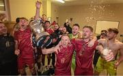 20 October 2023; Galway United captain Conor McCormack holds the trophy aloft as he celebrates with team-mate Rob Slevin in the dressing room after the SSE Airtricity Men's First Division match between Galway United and Wexford at Eamonn Deacy Park in Galway. Photo by Stephen McCarthy/Sportsfile