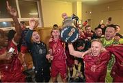 20 October 2023; Galway United captain Conor McCormack celebrates with the trophy in the dressing room after the SSE Airtricity Men's First Division match between Galway United and Wexford at Eamonn Deacy Park in Galway. Photo by Stephen McCarthy/Sportsfile