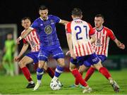 20 October 2023; Ronan Coughlan of Waterford in action against Treaty United players, from left, Ben O'Riordan, Colin Conroy, and Lee Devitt during the SSE Airtricity Men's First Division match between Waterford and Treaty United at RSC in Waterford. Photo by Michael P Ryan/Sportsfile