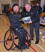 21 October 2023; GAA Carlow county chairperson Jim Bolger presents Ireland player Ciaran Bradley of Ulster with a commemorative plaque for their trip to Prague earlier this year before the 2023 Wheelchair Hurling / Camogie All Ireland Finals at SETU Carlow Sports Hall in Carlow. Photo by Ben McShane/Sportsfile