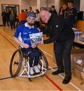 21 October 2023; GAA Carlow county chairperson Jim Bolger presents Ireland player Cian Horgan of Munster with a commemorative plaque for their trip to Prague earlier this year before the 2023 Wheelchair Hurling / Camogie All Ireland Finals at SETU Carlow Sports Hall in Carlow. Photo by Ben McShane/Sportsfile
