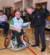 21 October 2023; GAA Carlow county chairperson Jim Bolger presents Ireland player Sean Bennett of Leinster with a commemorative plaque for their trip to Prague earlier this year before the 2023 Wheelchair Hurling / Camogie All Ireland Finals at SETU Carlow Sports Hall in Carlow. Photo by Ben McShane/Sportsfile