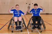 21 October 2023; Munster players Sean Hassett, left, and Cormac Downey celebrate with the cup after the 2023 Wheelchair Hurling / Camogie All Ireland Final match between Ulster and Munster at SETU Carlow Sports Hall in Carlow. Photo by Ben McShane/Sportsfile