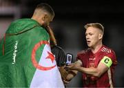 20 October 2023; Galway United captain Conor McCormack presents Wassim Aouachria with his SSE Airtricity Men's First Division winners medal after the SSE Airtricity Men's First Division match between Galway United and Wexford at Eamonn Deacy Park in Galway. Photo by Stephen McCarthy/Sportsfile