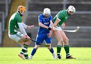 21 October 2023; Ruaridh Anderson of Scotland in action against Cillian Kiely, left, and Ryan Mullaney of Ireland during the 2023 Hurling Shinty International Game between Ireland and Scotland at Páirc Esler in Newry, Down. Photo by Piaras Ó Mídheach/Sportsfile