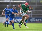 21 October 2023; Fionan Mackessy of Ireland in action against Daniel MacCuish of Scotland during the 2023 Hurling Shinty International Game between Ireland and Scotland at Páirc Esler in Newry, Down. Photo by Piaras Ó Mídheach/Sportsfile