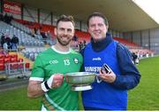 21 October 2023; Ireland captain Neil McManus and Ireland manager Damien Coleman celebrate with the Mowi Quaich after the 2023 Hurling Shinty International Game between Ireland and Scotland at Páirc Esler in Newry, Down. Photo by Piaras Ó Mídheach/Sportsfile