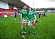 21 October 2023; Ireland players Peter Duggan, left, Thomas Monaghan after their side's victory in the 2023 Hurling Shinty International Game between Ireland and Scotland at Páirc Esler in Newry, Down. Photo by Piaras Ó Mídheach/Sportsfile