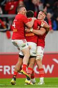 21 October 2023; Antoine Frisch of Munster, centre, celebrates with teammates Andrew Conway, left, and Gavin Coombes after scoring their side's third try during the United Rugby Championship match between Munster and Hollywoodbets Sharks at Thomond Park in Limerick. Photo by Seb Daly/Sportsfile