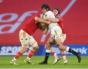 21 October 2023; Emile van Heerden of Hollywoodbets Sharks is tackled by Munster players Gavin Coombes, left,m and Rory Scannell during the United Rugby Championship match between Munster and Hollywoodbets Sharks at Thomond Park in Limerick. Photo by Seb Daly/Sportsfile