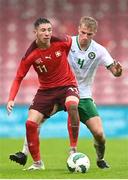 17 October 2023; Andrej Vasovic of Switzerland in action against Luca Cailloce of Republic of Ireland during the UEFA European U17 Championship qualifying group 10 match between Switzerland and Republic of Ireland at Turner's Cross in Cork. Photo by Eóin Noonan/Sportsfile