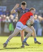22 October 2023; Donal McKenny of Ardee St Mary's is tackled by Evan Whelan of Naomh Mairtin during the Louth County Senior Club Football Championship final between Ardee St Mary's and Naomh Mairtin at Pairc Naomh Bríd in Dowdallshill, Louth. Photo by Stephen Marken/Sportsfile