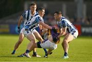 22 October 2023; Rory O'Carroll of Kilmacud Crokes is tackled by Ryan Basquel, left, and Colm Basquel of Ballyboden St Endas during the Dublin County Senior Club Football Championship Final between Kilmacud Crokes and Ballyboden St Endas at Parnell Park in Dublin. Photo by Brendan Moran/Sportsfile