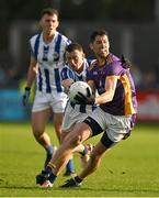 22 October 2023; Rory O'Carroll of Kilmacud Crokes is tackled by /d14 during the Dublin County Senior Club Football Championship Final between Kilmacud Crokes and Ballyboden St Endas at Parnell Park in Dublin. Photo by Brendan Moran/Sportsfile