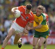 11 July 2004; Philip Loughran, Armagh, is tackled by Stephen McDermott, Donegal. Bank of Ireland Ulster Senior Football Championship Final, Armagh v Donegal, Croke Park, Dublin. Picture credit; Matt Browne / SPORTSFILE