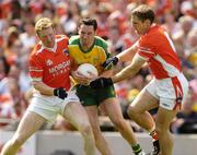 11 July 2004; Brendan Devenney, Donegal, is tackled by Francie Bellew,left, and Kieran McGeeney, Armagh. Bank of Ireland Ulster Senior Football Championship Final, Armagh v Donegal, Croke Park, Dublin. Picture credit; Matt Browne / SPORTSFILE