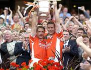 11 July 2004; Armagh captain Kiaran McGeeney and team-mate Paul McGrane, right, lift the Anglo Celt cup. Bank of Ireland Ulster Senior Football Championship Final, Armagh v Donegal, Croke Park, Dublin. Picture credit; Damien Eagers / SPORTSFILE
