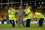 6 September 2013; A supporter who ran on to the pitch during the second half is escorted off by security. 2014 FIFA World Cup Qualifier, Group C, Republic of Ireland v Sweden, Aviva Stadium, Lansdowne Road, Dublin. Picture credit: David Maher / SPORTSFILE