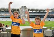 7 September 2013; On the eve of the All-Ireland Hurling Final, Clare hurling legend Jamesie O’Connor gave a unique tour of Croke Park stadium as part of the Bord Gáis Energy Legends Tour Series. Pictured holding the Liam MacCarthy Cup at the tour are Jamesie's duaghter and son Meadhbh and Mark O'Connor, aged 10 and 7, from Ennis, Co. Clare. The Final Bord Gáis Energy Legends Tour of the year will take place on Saturday, 21st September and will feature former Mayo player, Willie Joe Padden. Full details are available on www.crokepark.ie/events. Croke Park, Dublin. Picture credit: Barry Cregg / SPORTSFILE