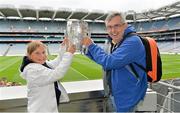 7 September 2013; On the eve of the All-Ireland Hurling Final, Clare hurling legend Jamesie O’Connor gave a unique tour of Croke Park stadium as part of the Bord Gáis Energy Legends Tour Series. Pictured holding the Liam MacCarthy Cup at the tour are Donagh Kennedy and his daughter Ellen, aged 10, from Mincloon, Co. Galway. The Final Bord Gáis Energy Legends Tour of the year will take place on Saturday, 21st September and will feature former Mayo player, Willie Joe Padden. Full details are available on www.crokepark.ie/events. Croke Park, Dublin. Picture credit: Barry Cregg / SPORTSFILE