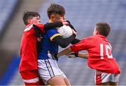 24 October 2023; Rían Kearney of St Mochta's NS is tackled by Ryan Freeman, left, and Charlie Callinan of St Benedict's National School during the match between St Mochta's NS and St Benedict's National School at the Allianz Cumann na mBunscol Finals at Croke Park in Dublin. Photo by Ben McShane/Sportsfile