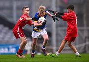 24 October 2023; Charlie Rowe of St Mochta's NS is tackled by Charlie Tallon, left, and Ryan Freeman of St Benedict's National School during the match between St Mochta's NS and St Benedict's National School at the Allianz Cumann na mBunscol Finals at Croke Park in Dublin. Photo by Ben McShane/Sportsfile