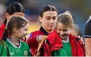27 October 2023; Albania captain Megi Doci gives her jacket to a mascot before the UEFA Women's Nations League B match between Republic of Ireland and Albania at Tallaght Stadium in Dublin. Photo by David Fitzgerald/Sportsfile