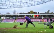 27 October 2023; Groundsman Kevin McCabe spreads sand on the pitch before the SSE Airtricity Men's Premier Division match between Cork City and Derry City at Turner's Cross in Cork. Photo by Eóin Noonan/Sportsfile