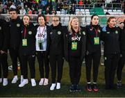 27 October 2023; Republic of Ireland staff, from left, nutritionist Dr Brendan Egan, social media coordinator Emma Clinton, equipment officer Helen Noonan, STATSports analyst Claire Dunne, operations manager Evelyn McMullan, physiotherapist Susie Coffey and Dr Siobhan Forman, team doctor, stand for the playing of the National Anthem before the UEFA Women's Nations League B match between Republic of Ireland and Albania at Tallaght Stadium in Dublin. Photo by Stephen McCarthy/Sportsfile