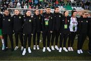 27 October 2023; Republic of Ireland players and staff, from left, Sinead Farrelly, Amber Barrett, Lucy Quinn, Heather Payne, Derek McDonnell, operations; nutritionist Dr Brendan Egan, social media coordinator Emma Clinton, equipment officer Helen Noonan and STATSports analyst Claire Dunne stand for the playing of the National Anthem before the UEFA Women's Nations League B match between Republic of Ireland and Albania at Tallaght Stadium in Dublin. Photo by Stephen McCarthy/Sportsfile