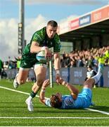 28 October 2023; Diarmuid Kilgallen of Connacht dives over to score his side's first try despite the tackle of Kyle Rowe of Glasgow Warriors during the United Rugby Championship match between Connacht and Glasgow Warriors at The Sportsground in Galway. Photo by Ramsey Cardy/Sportsfile