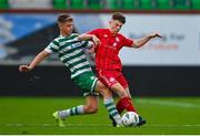 28 October 2023; Corman O'Donoghue of Shelbourne is tackled by Tristian Donnelly of Shamrock Rovers during the EA SPORTS MU17 LOI Mark Farren Cup match between Shamrock Rovers and Shelbourne at Tallaght Stadium in Dublin. Photo by Tyler Miller/Sportsfile