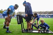28 October 2023; Matchday mascots Samuel Bayley, aged nine, and Harry Cronin, aged seven, help Michael Ala'alatoa of Leinster warm up with Leinster forwards and scrum coach Robin McBryde before during the United Rugby Championship match between Leinster and Hollywoodbets Sharks at the RDS Arena in Dublin. Photo by Harry Murphy/Sportsfile