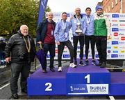 29 October 2023; Pictured, from left, at the Men's National Championship podium, Athletics Ireland President John Cronin, Irish Sports Council Chief Executive and Olympian John Treacy, second place Ryan Creech from Cork, first place Stephen Scullion, third place Ryan Forsyth from Tipperary, and Race Director Jim Aughney after the 2023 Irish Life Dublin Marathon. Thousands of runners took to the Fitzwilliam Square start line, to participate in the 42nd running of the Dublin Marathon. Photo by Sam Barnes/Sportsfile *** NO REPRODUCTION FEE ***