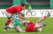 29 October 2023;  Antoine Frisch and Rory Scannell of Munster tackle Filippo Drago of Benetton Rugby during the United Rugby Championship match between Benetton and Munster at Stadio Monigo in Treviso, Italy. Photo by Massimiliano Carnabuci/Sportsfile