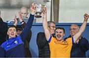 29 October 2023; Na Fianna joint captains Donal Burke and Sean Baxter lift the The New Ireland Assurance Company Perpetual Challenge Cup after their side's victory in the Dublin County Senior Club Hurling Championship final match between Ballyboden St Endas and Na Fianna at Parnell Park in Dublin. Photo by Stephen Marken/Sportsfile