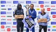 29 October 2023; The Men's event podium, from left, second place Geofrey Kusuro, first place Kemal Husen, and third place Stephen Scullion  after the 2023 Irish Life Dublin Marathon. Thousands of runners took to the Fitzwilliam Square start line, to participate in the 42nd running of the Dublin Marathon. Photo by Sam Barnes/Sportsfile