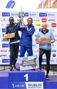 29 October 2023; The Men's event podium, from left, second place Geofrey Kusuro, first place Kemal Husen, and third place Stephen Scullion  after the 2023 Irish Life Dublin Marathon. Thousands of runners took to the Fitzwilliam Square start line, to participate in the 42nd running of the Dublin Marathon. Photo by Sam Barnes/Sportsfile