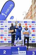 29 October 2023; The Men's event podium, from left, second place Geofrey Kusuro, first place Kemal Husen, and third place Stephen Scullion  after the 2023 Irish Life Dublin Marathon. Thousands of runners took to the Fitzwilliam Square start line, to participate in the 42nd running of the Dublin Marathon. Photo by Sam Barnes/Sportsfile