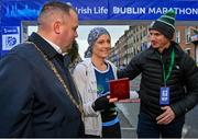 29 October 2023; Lord Mayor's Medal Recipient Rita Casey from Mayo, centre, with, from left, Lord Mayor of Dublin Cllr Daithí de Róiste, and husband John Casey, before the 2023 Irish Life Dublin Marathon. Thousands of runners took to the Fitzwilliam Square start line, to participate in the 42nd running of the Dublin Marathon. Photo by Sam Barnes/Sportsfile