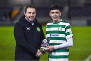 30 October 2023; Cory O'Sullivan of Shamrock Rovers receives the Player of the Match award from Republic of Ireland U19 head coach Tom Mohan after the EA SPORTS MU19 LOI Enda McGuill Cup match between Galway United and Shamrock Rovers at Eamonn Deacy Park in Galway. Photo by Ben McShane/Sportsfile