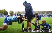 28 October 2023; Matchday mascots Harry Cronin, aged seven, and Samuel Bayley, aged nine, help Michael Ala'alatoa of Leinster warm up with Leinster forwards and scrum coach Robin McBryde before the United Rugby Championship match between Leinster and Hollywoodbets Sharks at the RDS Arena in Dublin. Photo by Harry Murphy/Sportsfile