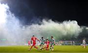 3 November 2023; Niall Morahan of Sligo Rovers in action against Neil Farrugia and Richie Towell of Shamrock Rovers as smoke rises from the south stand during the SSE Airtricity Men's Premier Division match between Shamrock Rovers and Sligo Rovers at Tallaght Stadium in Dublin. Photo by Stephen McCarthy/Sportsfile