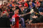 3 November 2023; Mark Connolly of Derry City hands a Derry City shirt to a supporter after the SSE Airtricity Men's Premier Division match between Derry City and St Patrick's Athletic at The Ryan McBride Brandywell Stadium in Derry. Photo by Ramsey Cardy/Sportsfile