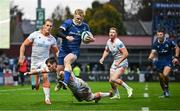 4 November 2023; Tommy O'Brien of Leinster beats the tackles of Blair Kinghorn and Duhan van der Merwe of Edinburgh on the way to scoring his side's fourth ty during the United Rugby Championship match between Leinster and Edinburgh at the RDS Arena in Dublin. Photo by Harry Murphy/Sportsfile