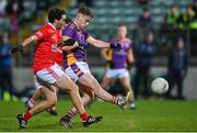 4 November 2023; Dan O’Brien of Kilmacud Crokes kicks a point, under pressure from Benny Kavanagh of Éire Óg, during the AIB Leinster GAA Football Senior Club Championship quarter-final match between Éire Óg and Kilmacud Crokes at Netwatch Cullen Park in Carlow. Photo by Seb Daly/Sportsfile